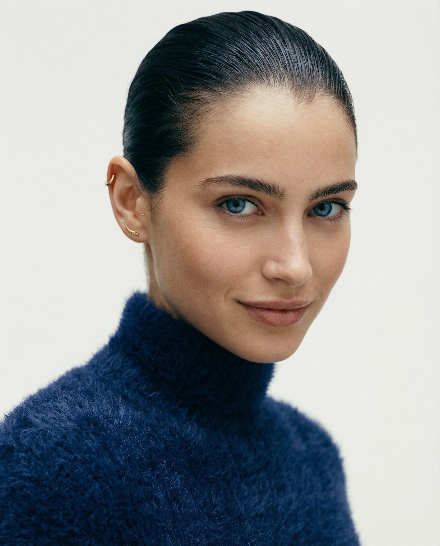 Frequency Paris-Ibiza Soluna Earrings styled on a model, sleek minimalist earrings with a contemporary edge. Perfect for a sophisticated stack. 