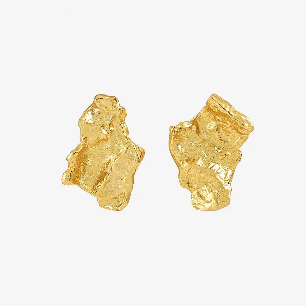 Grounding earrings in 18k gold-plated sterling silver with hammered, irregular design. Classic studs showcasing organic texture. Frequency Paris-Ibiza.