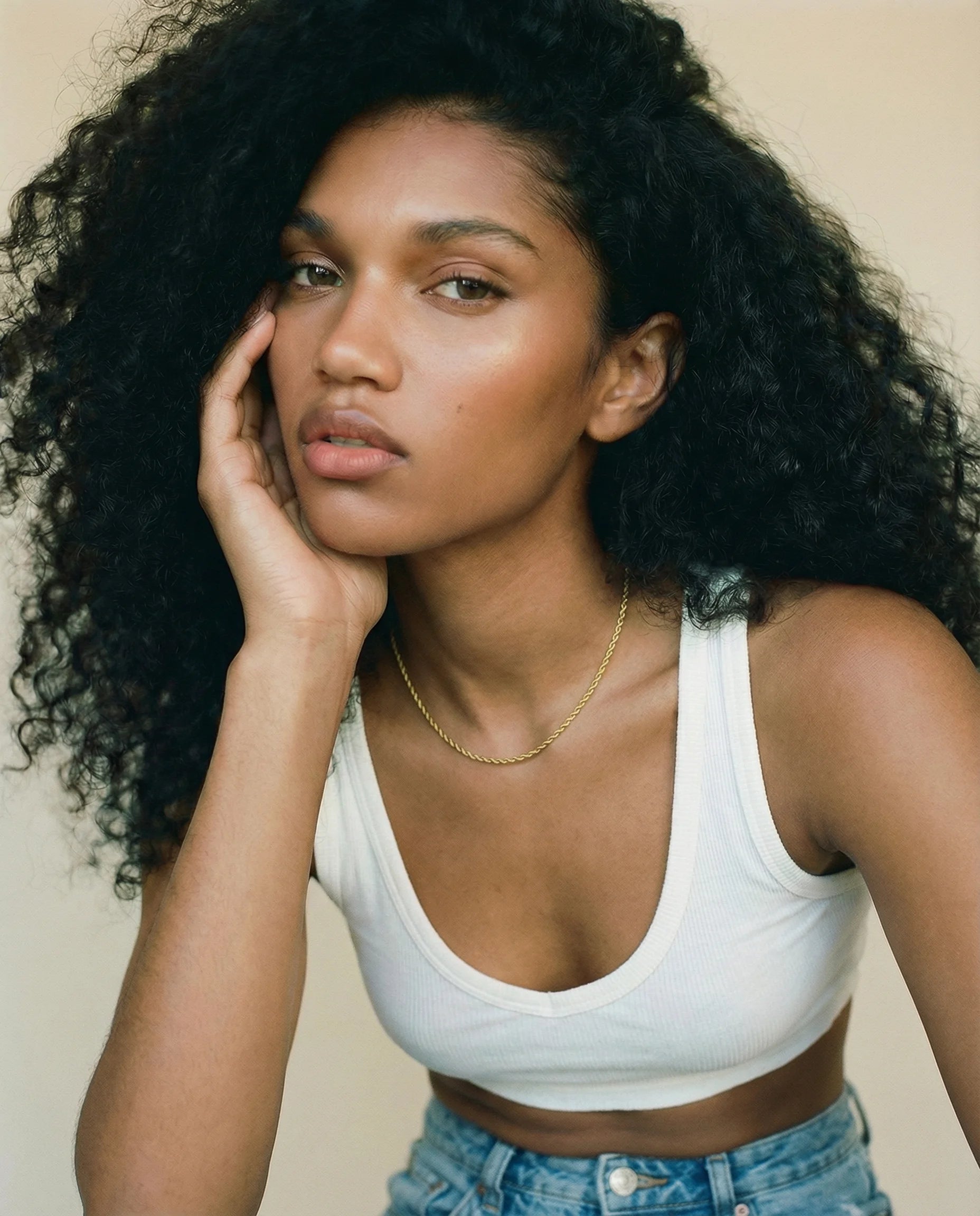 Positivity Gold Rope Chain Necklace by Frequency Paris-Ibiza styled on a model wearing a white crop top and faded blue jeans, a jewellery box staple for everyday wear.