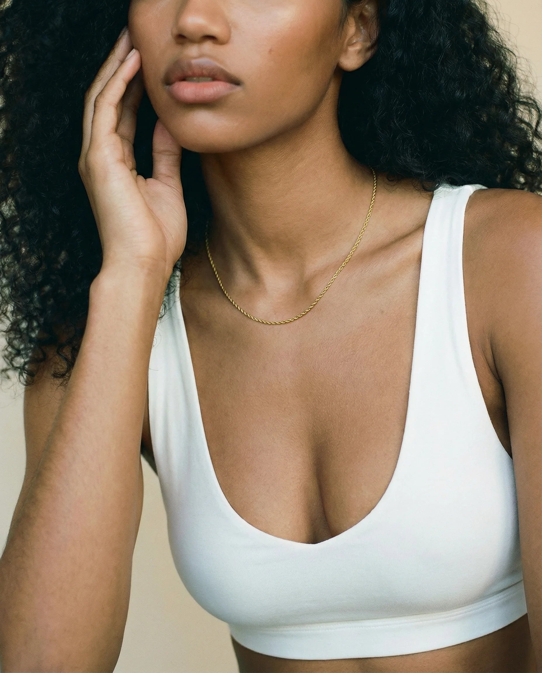 Positivity Gold Rope Chain Necklace by Frequency Paris-Ibiza worn on a model, showcasing its versatility—perfect for a chic, understated look. Looks stunning alone or as a stacking staple. 